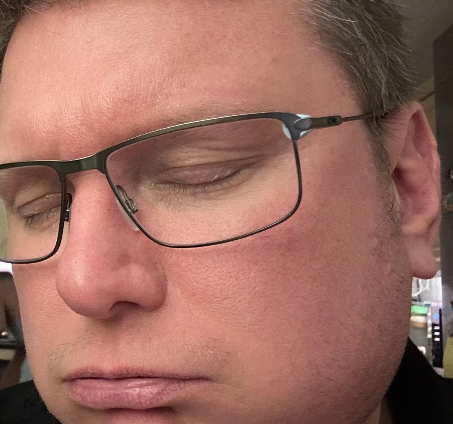 Graham, eyes shut and worn out at the kitchen counter.